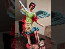 A statue of St. Michael the Archangel with what appears to have a substance resembling blood dripping from his forehead.