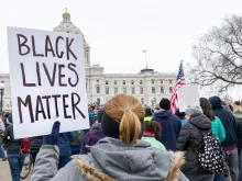 Protestor carrying Black Lives Matter sign. 