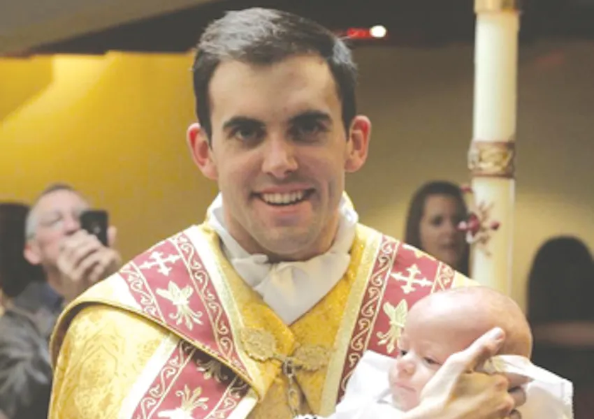 Fr. Zachary Boazman, left, after the baptism of a baby, right. ?w=200&h=150