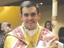Fr. Zachary Boazman, left, after the baptism of a baby, right. 