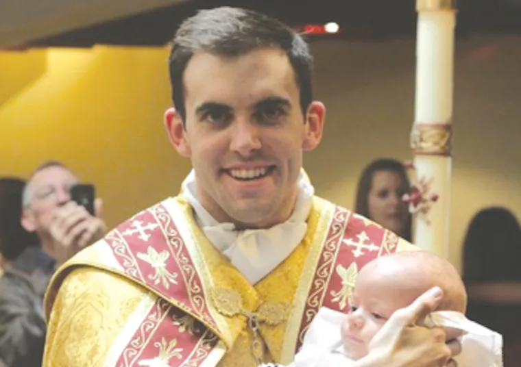 Fr. Zachary Boazman, left, after the baptism of a baby, right. Credit: Archdiocese of Oklahoma City