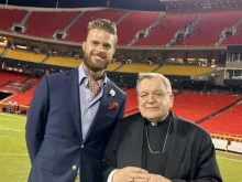 Harrison Butker and Cardinal Raymond Burke after Butker broke the Kansas City Chiefs’s field goal record in the 2022-2023 season.