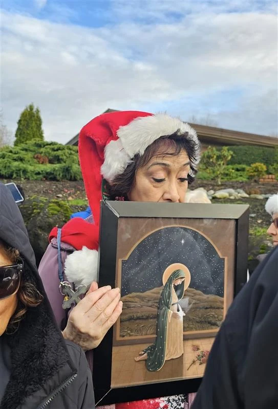 A caroler holds artwork of Mary, who is pregnant with Jesus, at a caroling event outside a Cedar Rivers abortion facility in Renton, Washington, on Dec. 14, 2025. Credit: Photo courtesy of Richard Bray