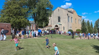 Children play as procession participants wait to enter the Shrine of St. Rose Philippine Duchesne for adoration.