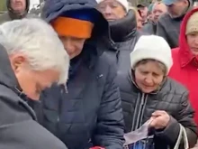 Cardinal Konrad Krajewski distributes food to Ukrainians on a recent humanitarian trip to the war-torn country.