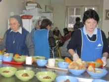 Caritas Greece volunteers serve locals. 