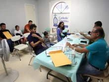 Volunteers at a Catholic Charities Humanitarian Respite Center help Central American refugees prepare to take a bus to go stay with U.S. family on Aug. 17, 2017, in McAllen, Texas.