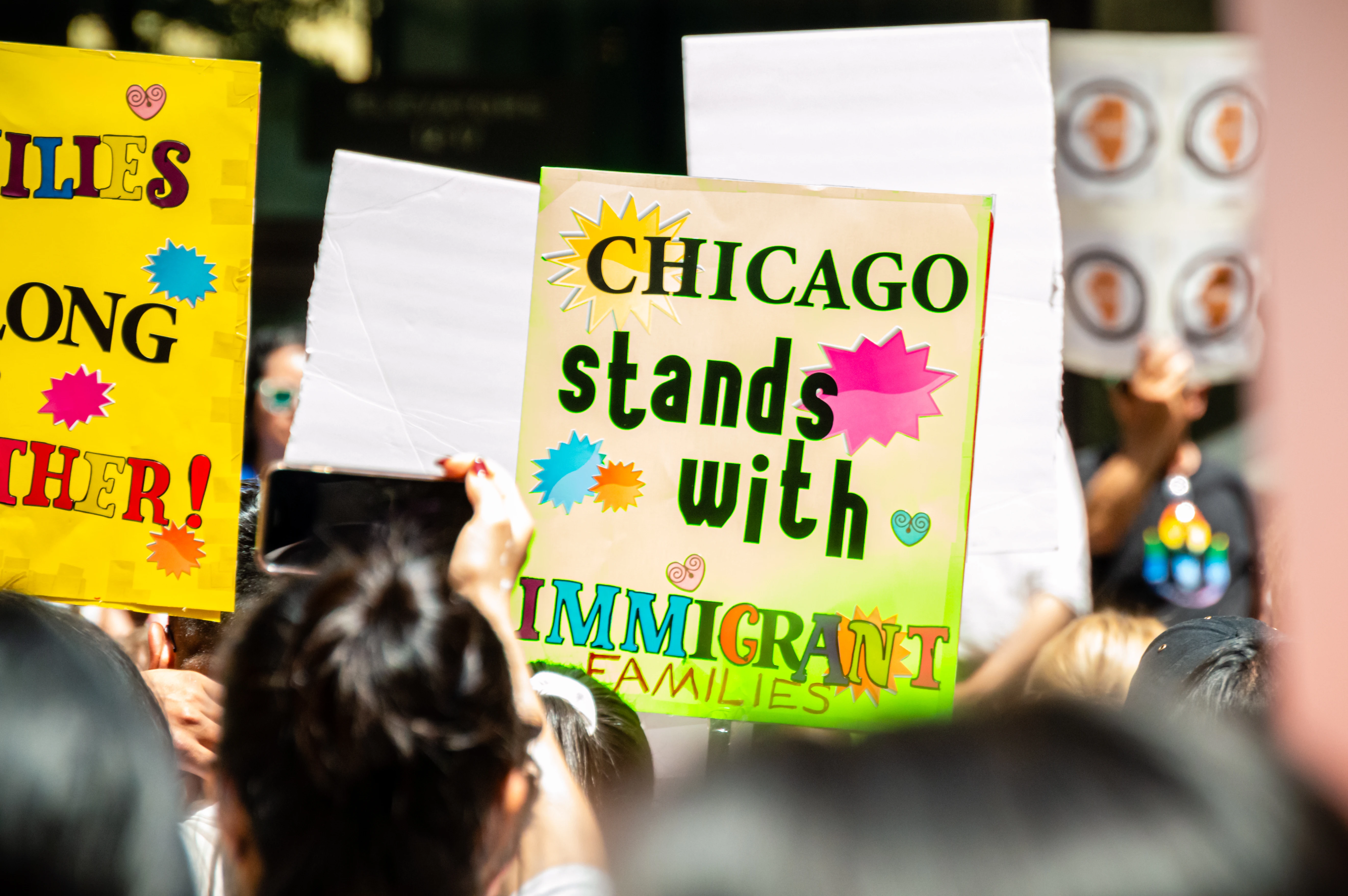A protest against Immigration and Customs Enforcement features a sign that reads “Chicago Stands With Immigrant Families.”  The Department of Homeland Security denies ICE targeted a Chicago parish on Oct. 12, 2025.?w=200&h=150
