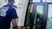 Chicago firefighters attend to a woman outside a doorway in video taken in November 2025 by Coalition Life.