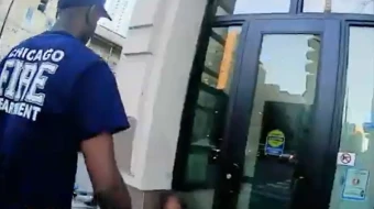 Chicago firefighters attend to a woman outside a doorway in video taken in November 2025 by Coalition Life.