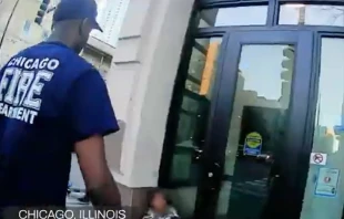 Chicago firefighters attend to a woman outside a doorway in video taken in November 2025 by Coalition Life. Credit: Courtesy of Coalition Life’s YouTube channel
