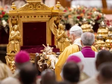 Pope Leo XIV venerates a statue of the Child Jesus during the celebration of Christmas Mass during the Night in St. Peter's Basilica on Dec. 24, 2025.