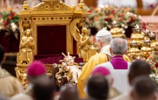 Pope Leo XIV venerates a statue of the Child Jesus during the celebration of Christmas Mass during the Night in St. Peter's Basilica on Dec. 24, 2025. Credit: Daniel Ibanez/CNA.