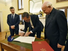 Chuck Robbins, the chief executive of the multinational digital communications conglomerate Cisco, signs the Rome Call for AI Ethics, a document by the Pontifical Academy for Life, on April 24, 2024, at the Vatican.