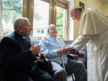 Pope Francis greets the elderly priest-residents of Casa San Gaetano in Rome on June 17, 2016.