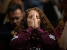 A Massgoer prays at St. Patrick’s Cathedral in New York City before a Eucharistic procession through the streets Oct. 10, 2023.