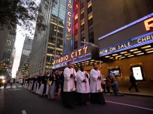 The cross, preceding the Blessed Sacrament, passes by during a Eucharistic procession on the streets of New York City on Oct. 10, 2023.