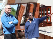 Archbishop Paul Coakley and Fr. Oby Zunmas inspect damage at Holy Cross Catholic Church. 