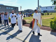 Bishop Earl Fernandes of Columbus, Ohio, carries the Blessed Sacrament during a procession at Pickaway Correctional Institution on June 28, 2024, at one of the stops on the Seton Route of the National Eucharistic Pilgrimage.