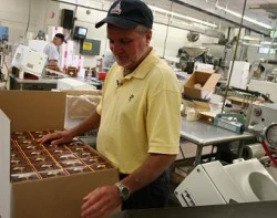 Tim Whitecross of the Cavanagh Company packages altar wafers on the production line. ?w=200&h=150