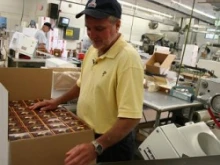 Tim Whitecross of the Cavanagh Company packages altar wafers on the production line. 