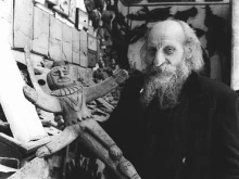 Father Carlo Crespi Croci (1891-1982) holding a crucifix from his ethnographic collection in Cuenca, Ecuador.