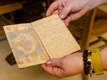 Archivists show a handwritten book of the Rule of St. Augustine found in the Sisters of Charity of St. Augustine’s archives, an example of the materials that will be preserved in WRAC’s future heritage center.