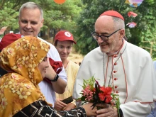 Cardinal Michael Czerny, SJ, receives flowers from Rohingya during his visit to Cox’s Bazar, considered the world’s largest refugee camp, on Sunday, Nov. 3, 2025.