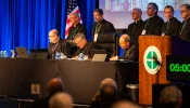 The plenary assembly of the United States Conference of Catholic Bishops gets underway on Nov. 11, 2025, at the Baltimore Marriott Waterfront. First row, left to right: Father Michael J.K. Fuller, general secretary; Archbishop Timothy P. Broglio, president, and Archbishop William E. Lori, vice president.
