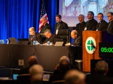 The plenary assembly of the United States Conference of Catholic Bishops gets underway on Nov. 11, 2025, at the Baltimore Marriott Waterfront. First row, left to right: Father Michael J.K. Fuller, general secretary; Archbishop Timothy P. Broglio, president, and Archbishop William E. Lori, vice president.