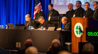 The plenary assembly of the United States Conference of Catholic Bishops gets underway on Nov. 11, 2025, at the Baltimore Marriott Waterfront. First row, left to right: Father Michael J.K. Fuller, general secretary; Archbishop Timothy P. Broglio, president, and Archbishop William E. Lori, vice president.