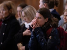 A woman prays in St. Peter's Basilica on Jan. 4, 2023, during the final day that the body of the late Pope Emeritus Benedict XVI is lying in state