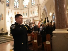 Lt. Matt Owens of the Arlington County Police Department plays the bugle in honor of fallen service members, at the annual Blue Mass on Tuesday May 6, 2025, at St. Patrick Cathlolic Church in Washington, D.C.