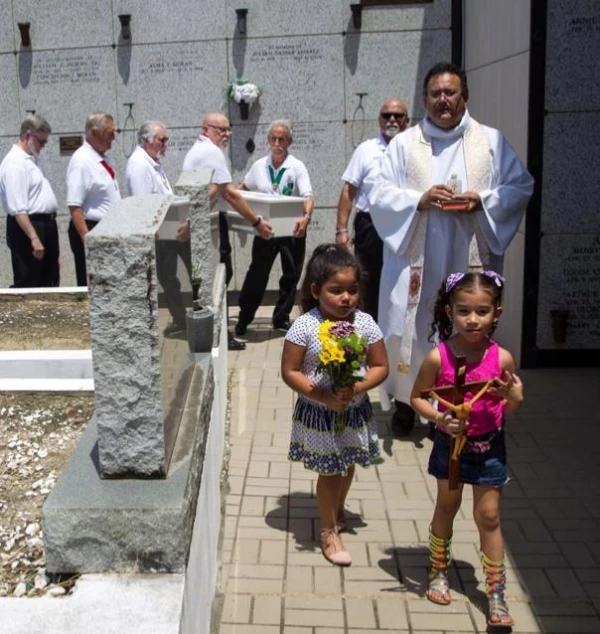 Two Knights of Columbus carry the casket of a baby who was murdered. Credit: Photo courtesy of Compassionate Burials for Indigent Babies