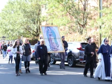 Marchers walk along with an image of Our Lady of Guadalupe during a pro-life Eucharistic Procession Oct. 2, 2021 in Denver.
