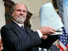Governor Jon Corzine holding the law banning the death penalty