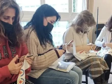 Volunteers create Sacred Heart of Jesus badges to be sent to Ukraine.