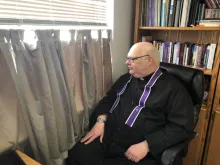 Fr. Douglas Dietrich prepares to hear confessions at his office window, at St. Mary's Parish in Lincoln, Neb. 