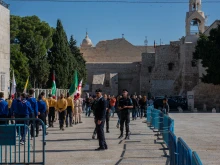 The small procession of Franciscan friars, with the Custos of the Holy Land, arrives in Manger Square, in front of the Basilica of the Nativity, in Bethlehem on Saturday, Dec. 2, the day of the solemn entrance for the beginning of Advent. The Square, typically crowded with local believers and pilgrims, was empty. Dec. 2, 2023.