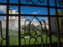A view of the separation wall between Israel and the Palestinian Territories from behind a window in the Comboni Sisters' house in East Jerusalem.