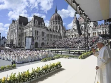 Pope Francis stands on an altar erected outside the Parliament Building in Budapest's Kossuth Lajos' Square during a public outdoor Mass on April 30, 2023.