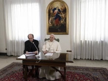 Papal aide Monsignor Paolo Braida reads Pope Francis' prepared remarks for the Sunday Angelus on Dec. 3, 2023, from the chapel at the papal residence at Casa Santa Marta.