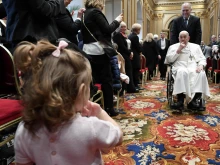 Pope Francis engages with a youngster at the inauguration of the 95th Judicial Year of the Vatican City State on Saturday, March 2, 2024.