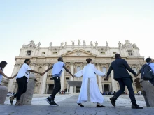 Young people from around the world held hands in St. Peter's Square during the #NotAlone human fraternity event June 10, 2023.