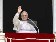 Pope Leo XIV waves to the crowd during his Angelus address on Aug. 24, 2025.