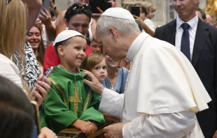 Pope Leo XIV greets a young papal admirer in St. Peter’s Basilica during the general audience on Wednesday, Aug. 20, 2025, at the Vatican. Credit: Vatican Media