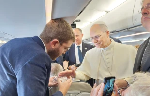 Pope Leo XIV blesses rosaries for EWTN News’ Elias Turk aboard the papal plane to Ankara, Turkey, on Nov. 27, 2025. Credit: Photo courtesy of Elias Turk/EWTN News