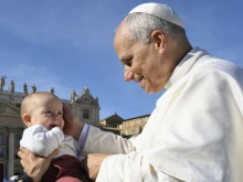 Pope Leo XIV blesses a baby on All Saints Day’ 2025.