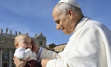 Pope Leo XIV blesses a baby on All Saints Day’ 2025.