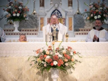 Archbishop Charles C. Thompson elevates the Eucharist during the Opening Mass at St. John the Evangelist Church in Indianapolis, marking the official launch of the St. Katharine Drexel Route. May 18, 2025.